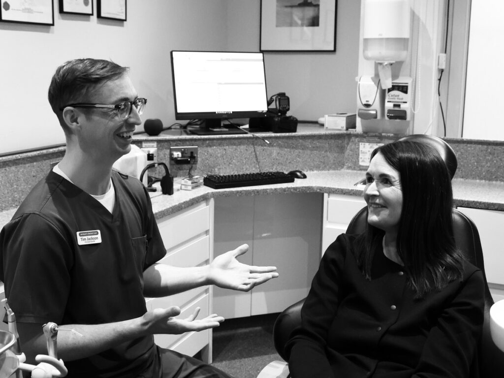 Tim Jackson, the principal dentist, having a discussion with a patient at a consultation visit